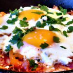 Savor Shakshuka: Fiery Eggs with Feta and Fresh Herbs